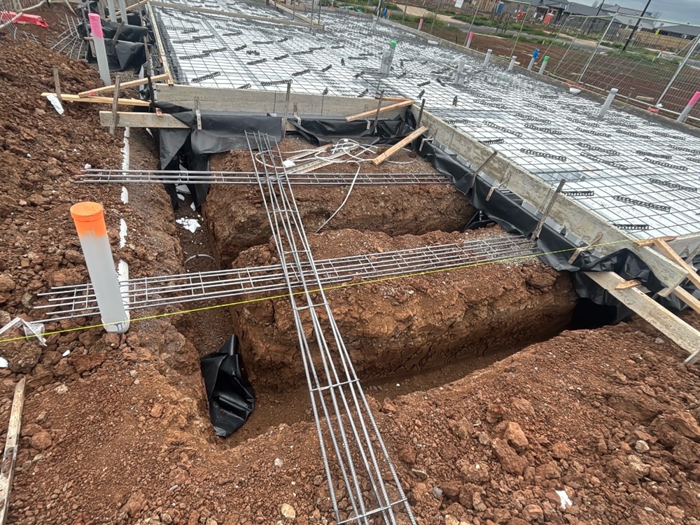 Vapour barrier not extended beneath the whole slab, recorded during a slab pre-pour inspection in Fraser Rise, 4 km from Rockbank